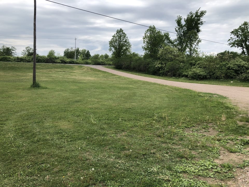 Driveway with large amount of space for cars and boats to park
