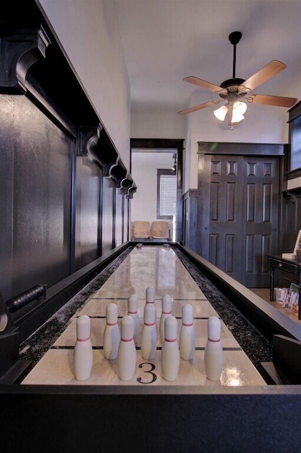 Shuffleboard with additional bowling game 