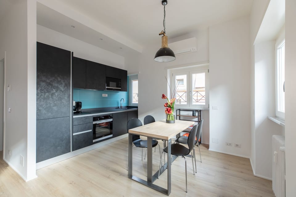 Living room and kitchen with many windows.