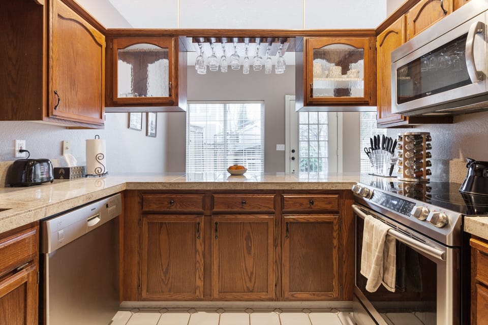 Kitchen opens to windows and door to the back yard