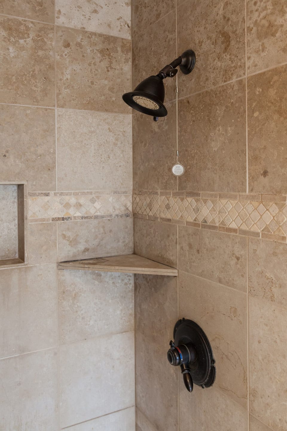Comfortable tiled shower in master bath