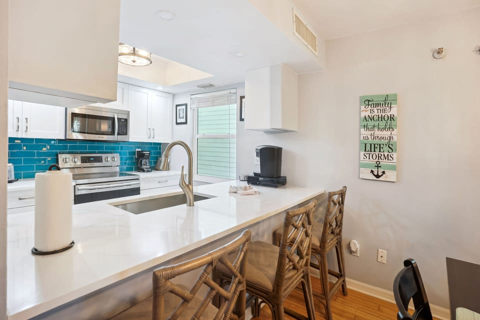Breakfast bar with seating adjoining the kitchen