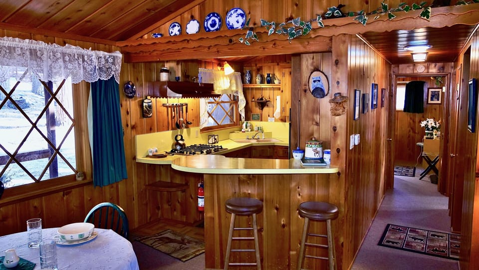 The quaint kitchen has everything you need, including extra cou - The quaint kitchen has everything you need, including extra counter space provided by the breakfast bar.