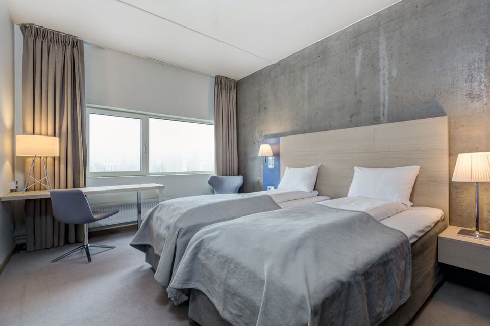 Desk, laptop workspace, iron/ironing board, bed sheets