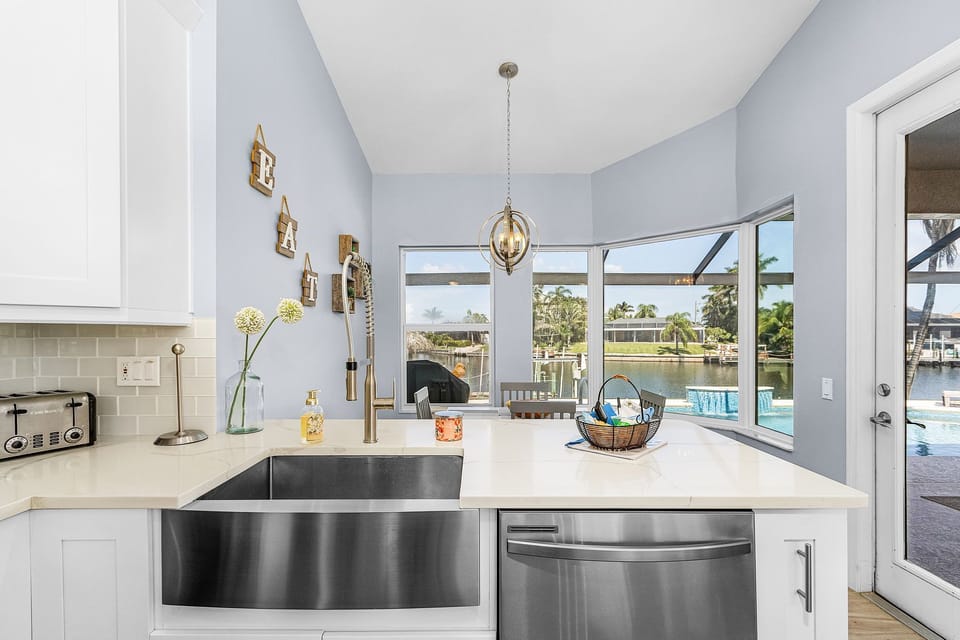 The kitchen offers a farmhouse sink & stainless steel appliances