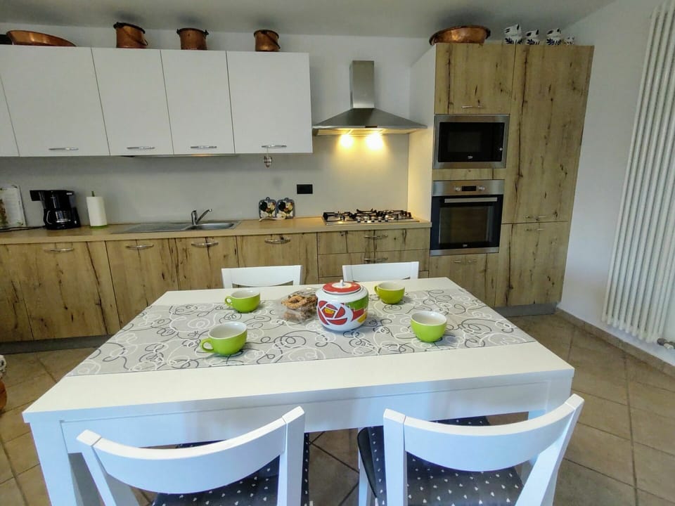 Furniture, Cabinetry, Table, Property, Countertop, Chair, Kitchen, Kitchen Appliance, Kitchen Stove, Tableware