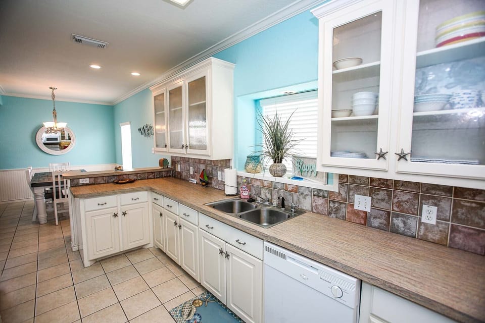 Kitchen and dining area, stocked with dishes, utensils, and pots/pans/appliances