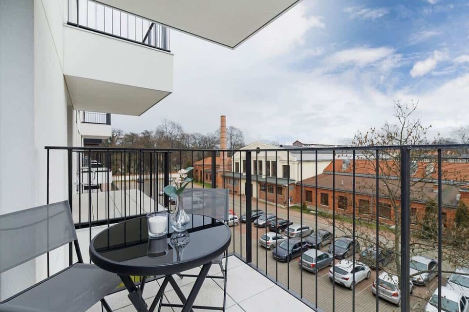 Spacious balcony with outdoor furniture. 
