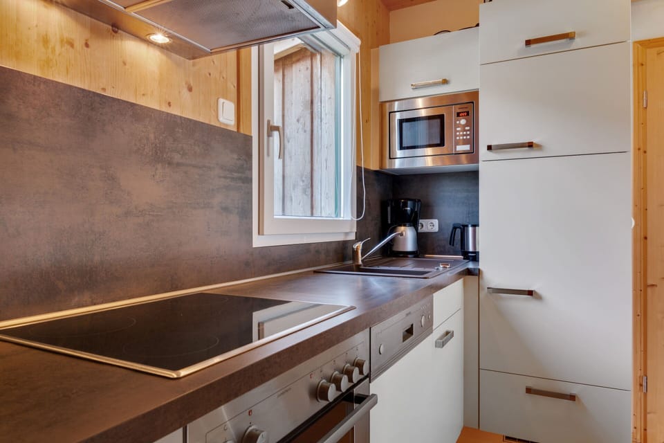 Chalet | Private kitchen | Stovetop, electric kettle, cookware/dishes/utensils, dining tables