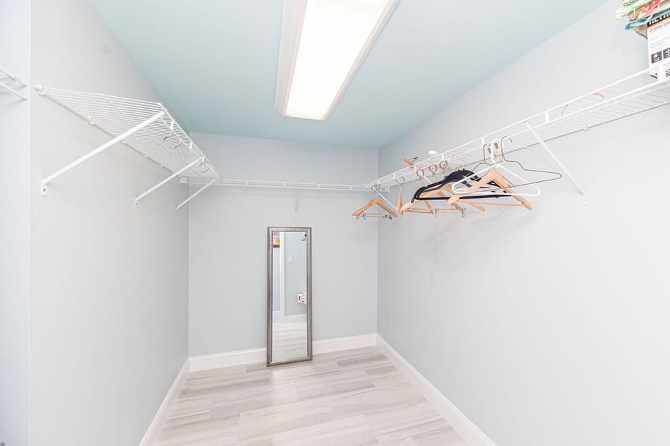 Your spacious walk-in closet offers ample storage with organized shelving and hanging space for all your vacation wardrobe.