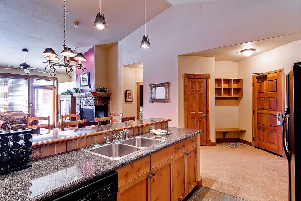 Cook together in your spacious kitchen with granite countertops, dual sinks, and warm wood cabinetry that flows into the welcoming living area.