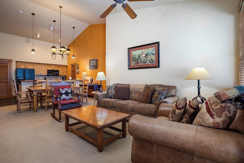 Sink into plush leather sofas in your spacious living area, where warm lighting and rustic charm create the perfect atmosphere for relaxing after your adventures.