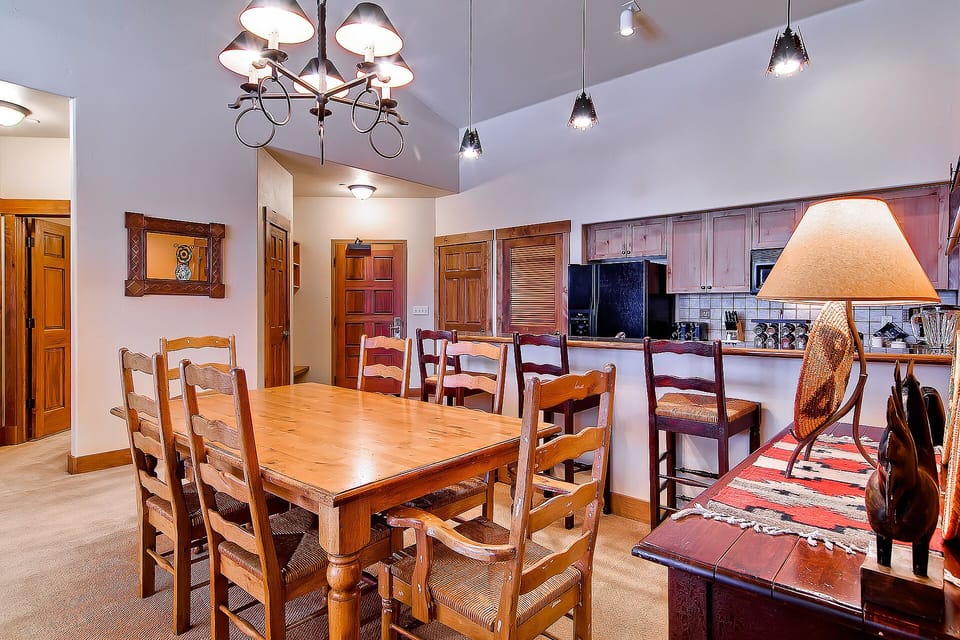 Gather around your spacious dining table where warm wood tones and rustic charm create the perfect setting for memorable meals together.