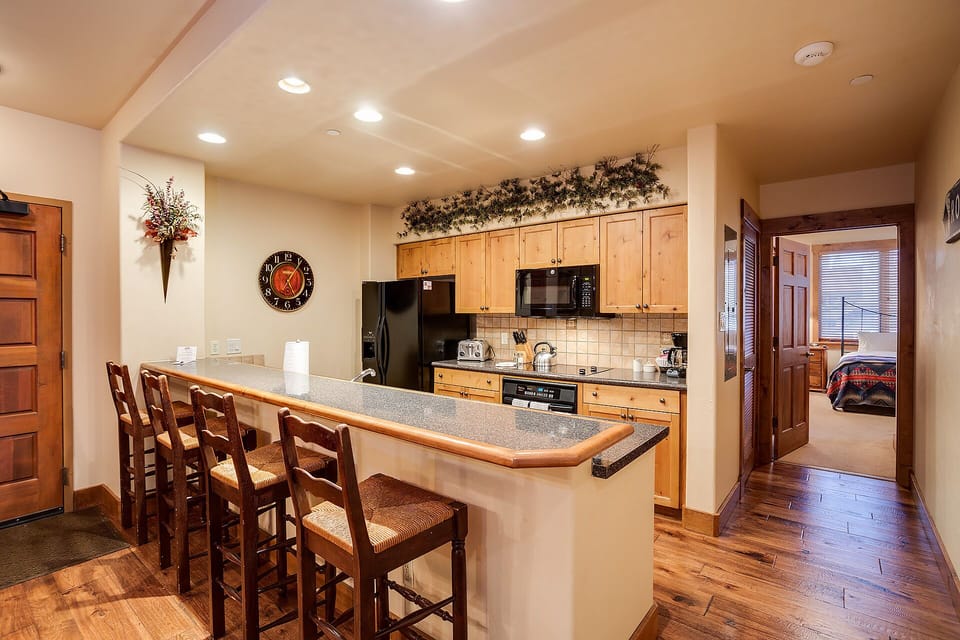 Gather around your spacious kitchen island for meals and conversation in this warm, inviting space with modern appliances and rustic charm.