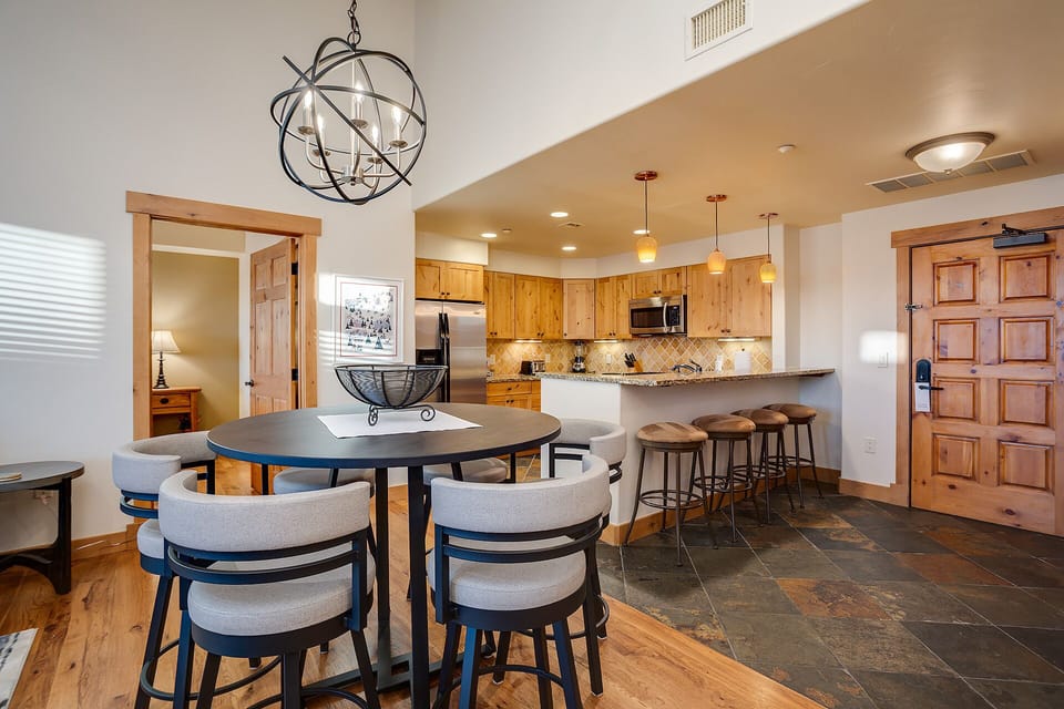 Gather around your spacious dining table beneath elegant lighting, then step into your fully equipped kitchen for cooking adventures.