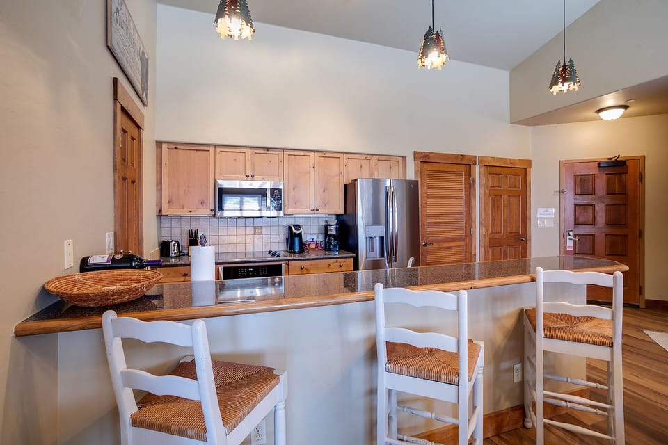 Gather around the spacious kitchen island where warm wood meets modern convenience, perfect for cooking together and sharing meals.