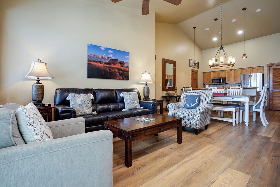 Unwind in your spacious living area with cozy seating, mountain views, and an open kitchen perfect for relaxing evenings together.