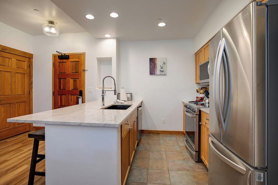 Your gourmet kitchen awaits with sleek stainless steel appliances and marble countertops perfect for preparing memorable meals.