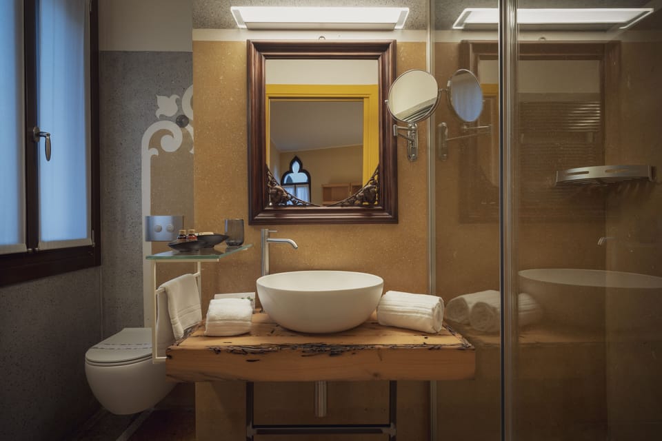 Shower, designer toiletries, hair dryer, slippers