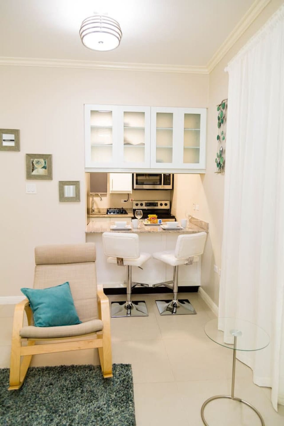 Intimate dining nook w/ a small table for two beside the open kitchen pass-through.