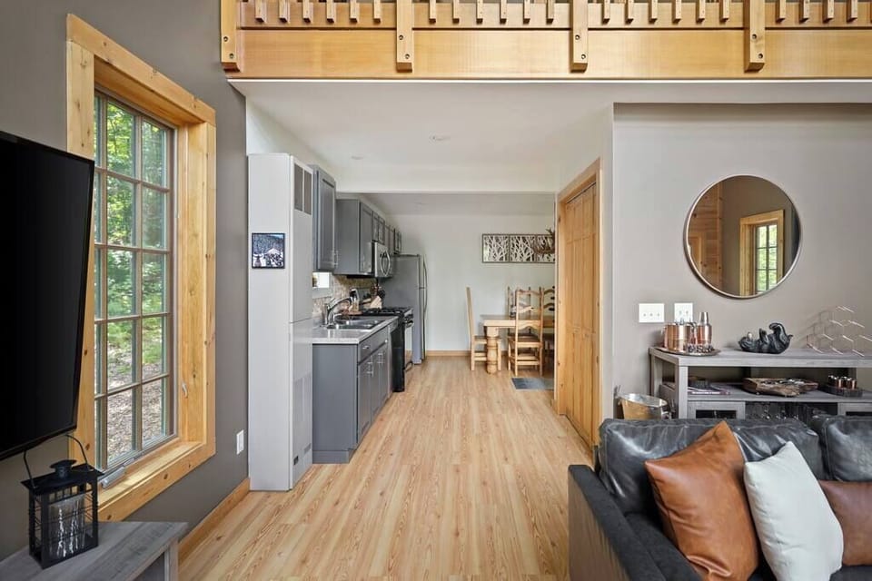 Open concept living room and kitchen area with Smart TV.