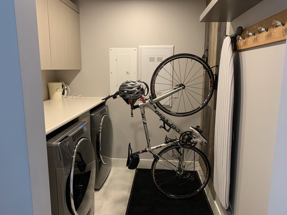 Laundry with lots of storage including two spots to hang bikes