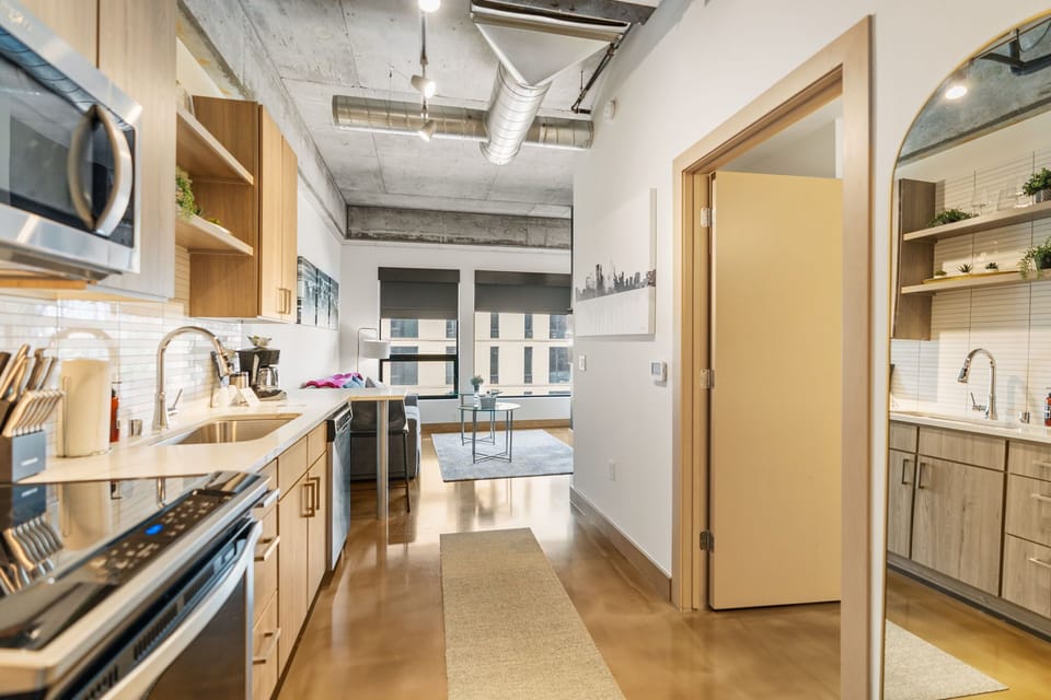 Your spacious modern kitchen features sleek appliances and warm wood cabinetry, creating the perfect culinary retreat.