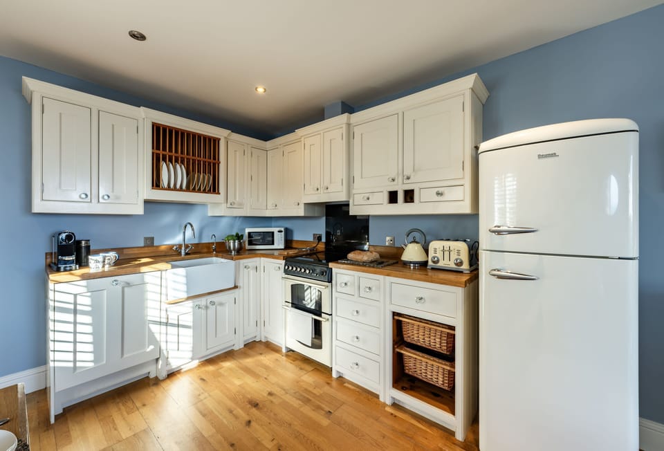 The View, Carbis Bay: The hand-built and painted oak kitchen with a cooker, microwave, dishwasher, fridge/freezer, washing machine and Nespresso coffee machine
