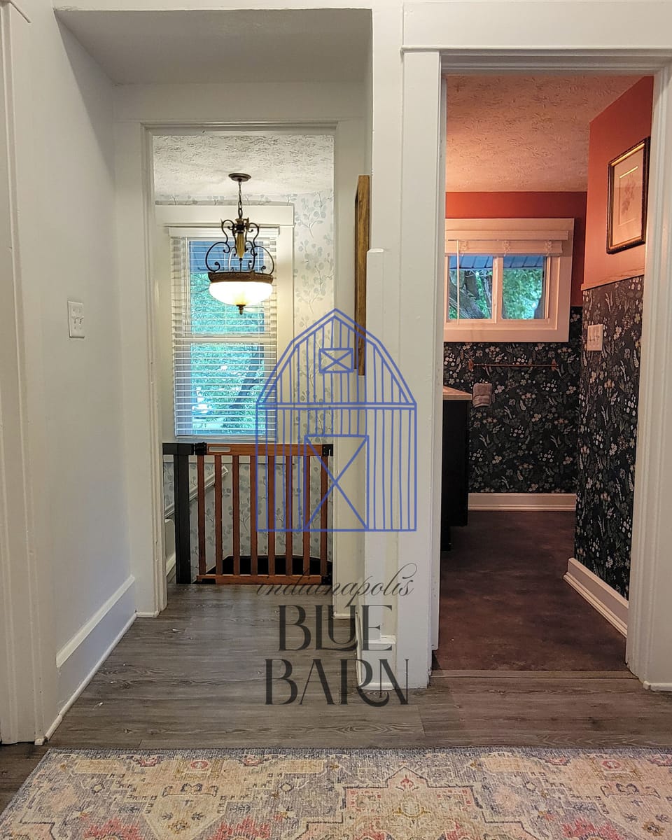 View of upstairs bathroom and baby gate for stairs.