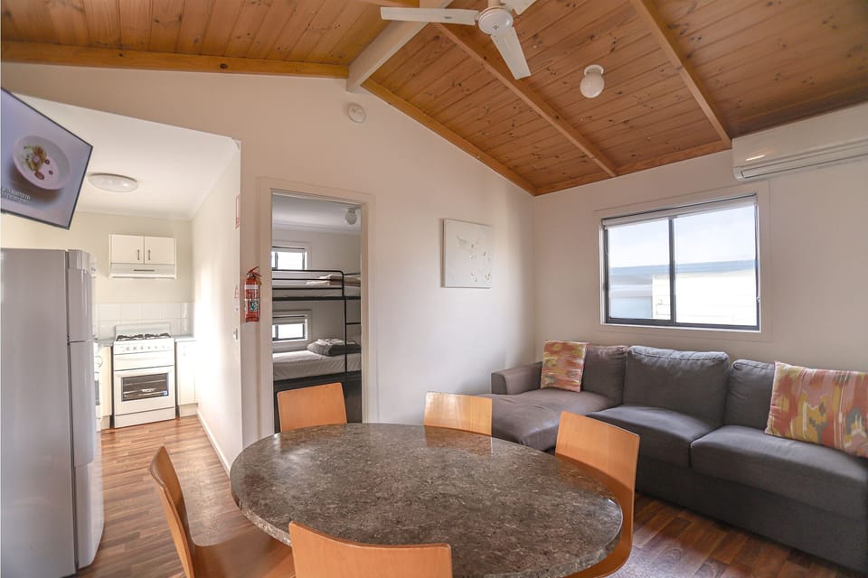 Family Two-Bedroom Cabin with Bunk Beds | Living area | 30-inch LCD TV with satellite channels