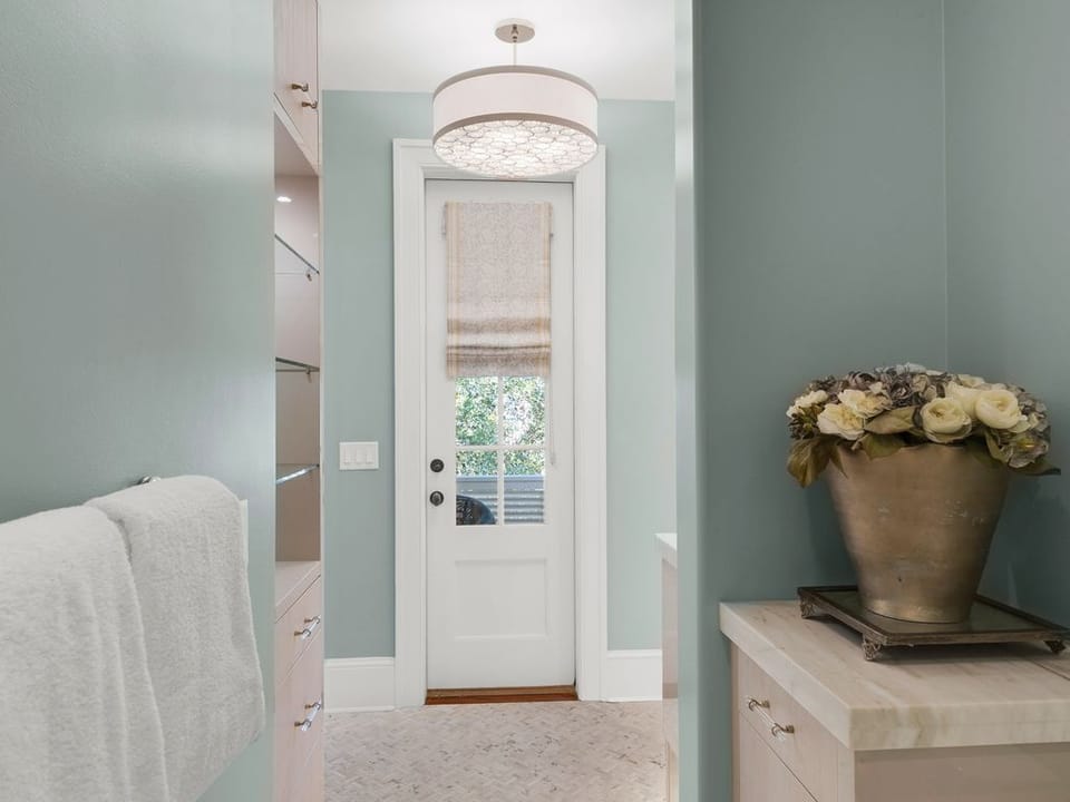 Door leading to balcony private shower  and lavatory area  in master ensuite