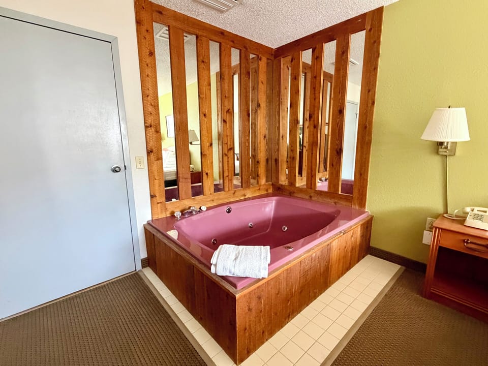 Deluxe Room, 1 Queen Bed, Jetted Tub | Iron/ironing board, cribs (free), WiFi (free), alarm clocks
