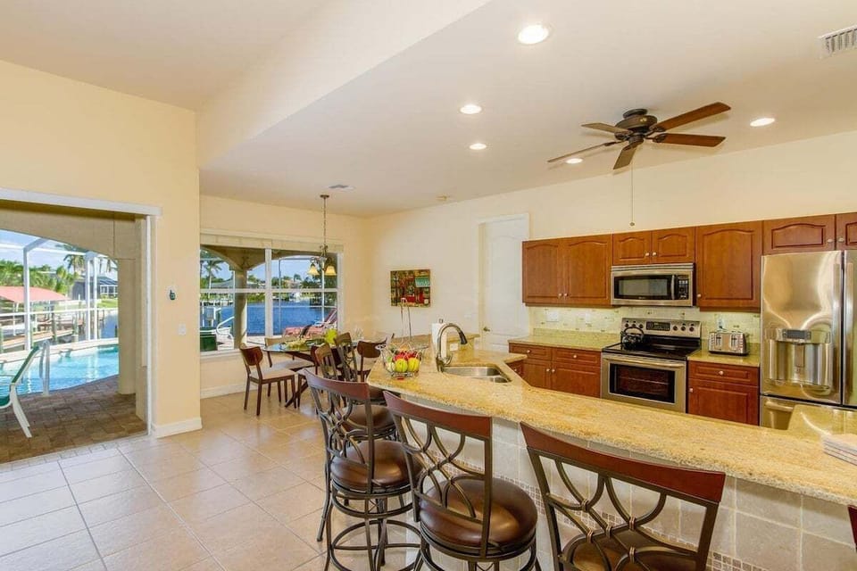The Kitchen Offers Views of the Living Room and is Open to the Formal Dining Space