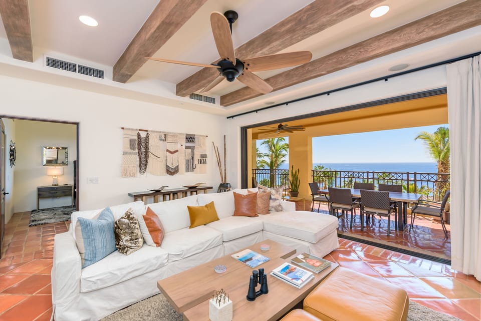 Floor to ceiling glass doors open to create indoor/outdoor living space