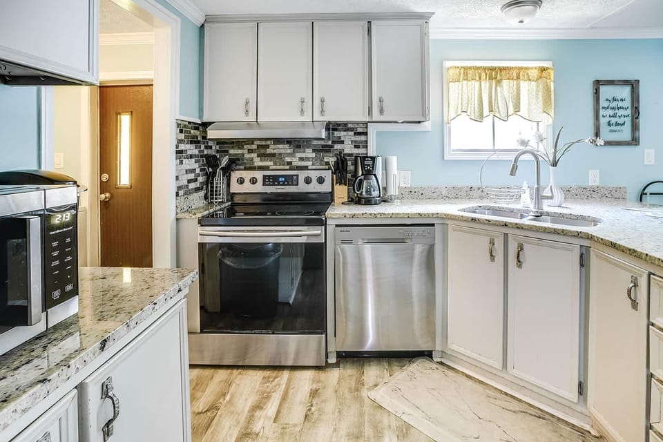 Bright, modern kitchen with stainless steel appliances and granite countertops