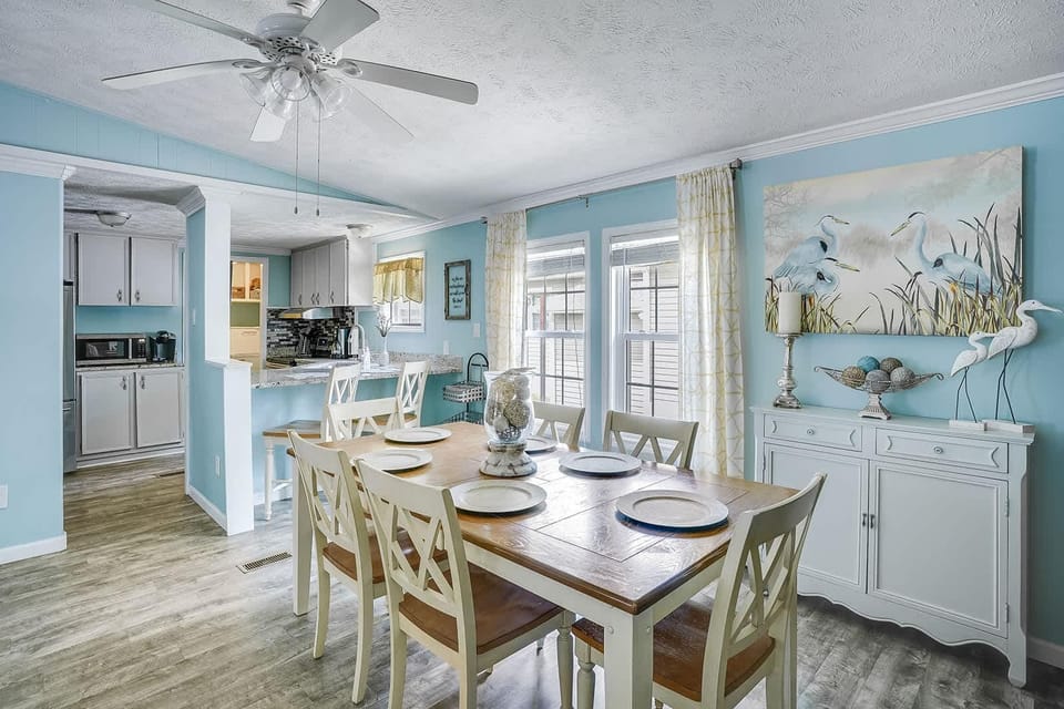 Bright and airy dining area with coastal charm and garden views