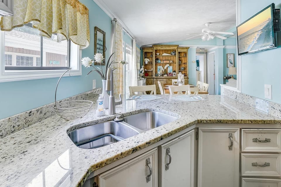 Bright kitchen with granite countertops and scenic window views