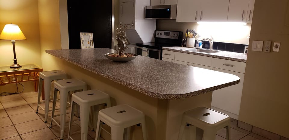 Fully stocked kitchen has seating for 5 and everything for meals at home.