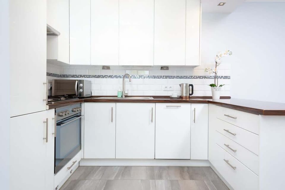 Kitchenette with oven and refrigerator. 