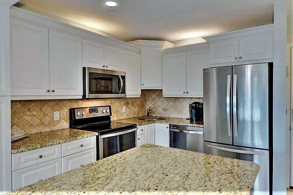 Full size kitchen with stove, micro, dishwasher, refrigerator, granite island