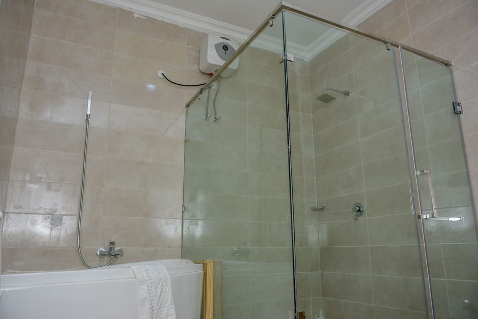 Executive Suite, 1 King Bed | Bathroom | Separate tub and shower, rainfall showerhead, designer toiletries