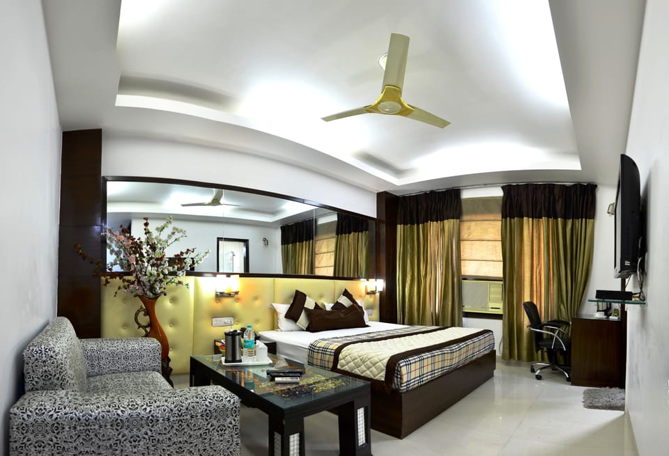 Deluxe Room | Living area | LCD TV, first-run movies