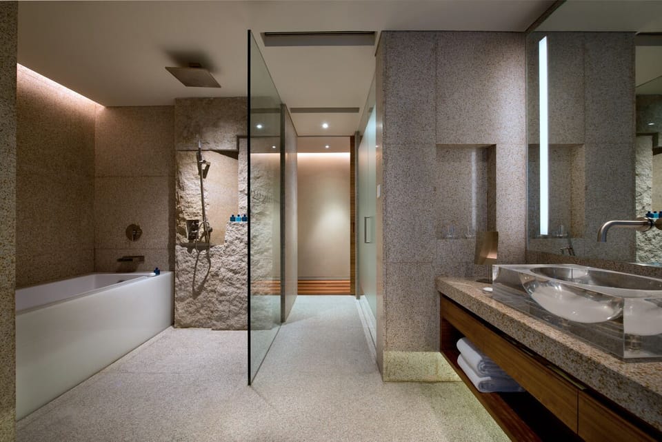 Separate tub and shower, designer toiletries, hair dryer, bathrobes