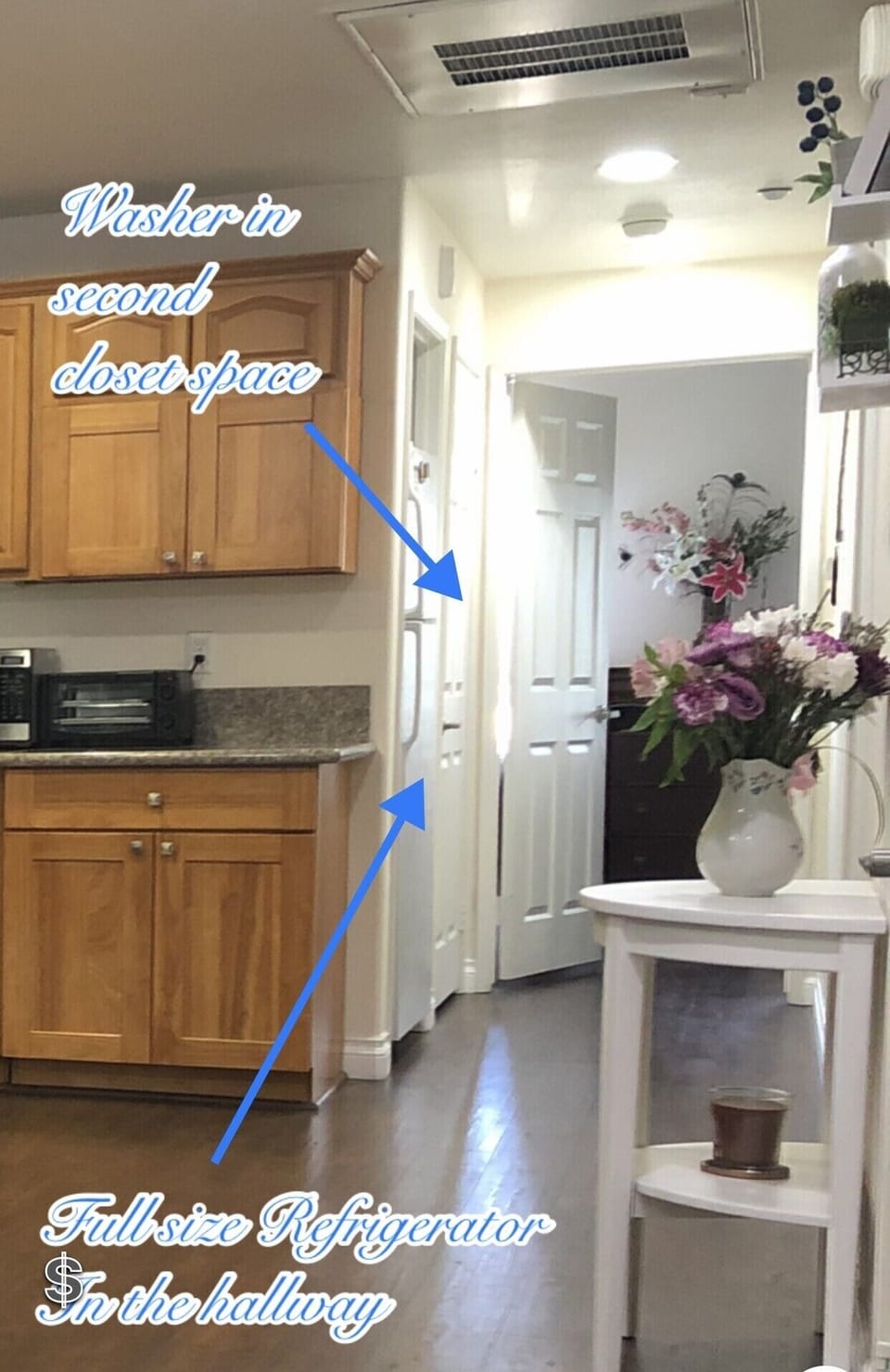 Full size fridge and washer tucked in the hallway
