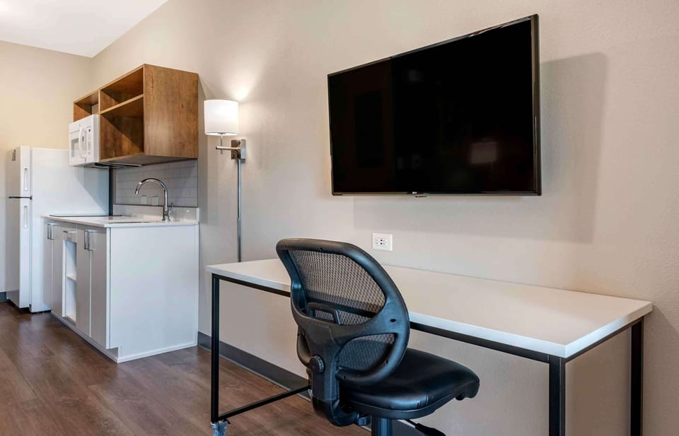 Premium bedding, desk, laptop workspace, iron/ironing board
