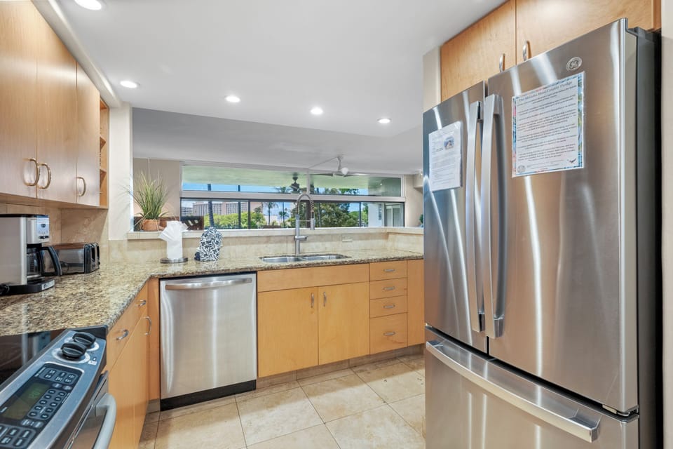 Kitchen from a different angle. New fridge has filtered water spigot inside.