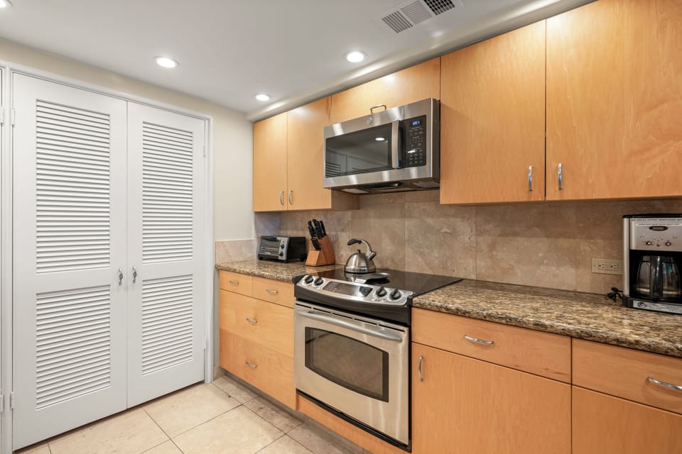 Kitchen from a different angle. Behind the louvered doors is additional storage.