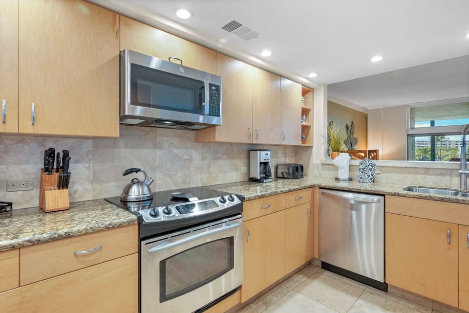 Kitchen with electric cook top, oven, dishwasher and microwave shown