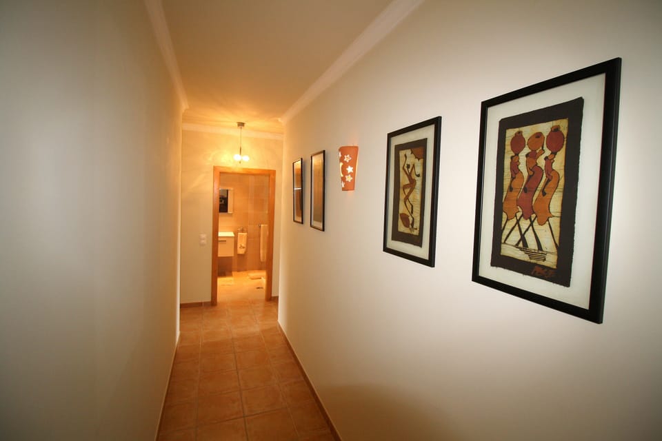 The bathroom is at the end of the hallway