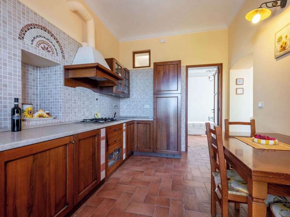 Flooring, Interior Design, Kitchen, Countertop, Floor, Cabinetry, Ceiling, Furniture, Kitchen Appliance, Lighting